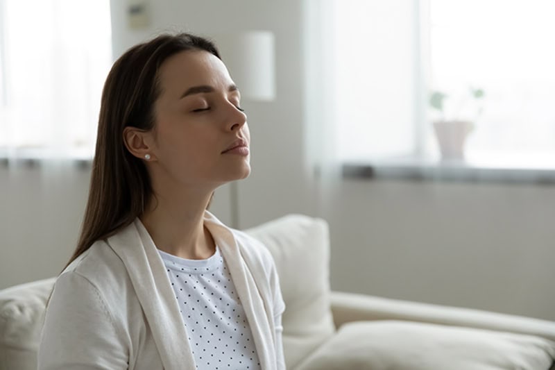 Female homeowner taking in her fresh indoor air quality in Edgewater, FL.